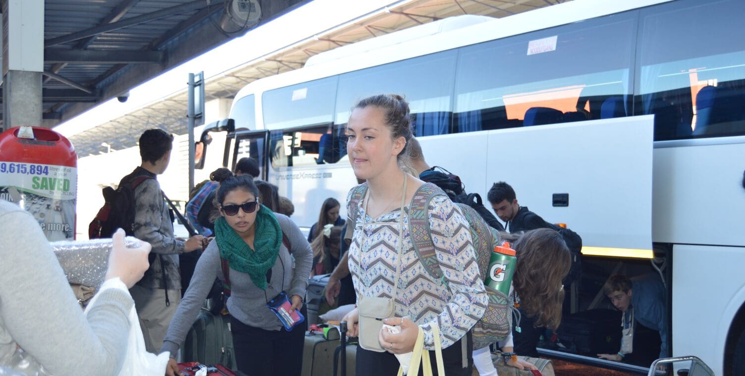 Tour Group at Airport with Bus