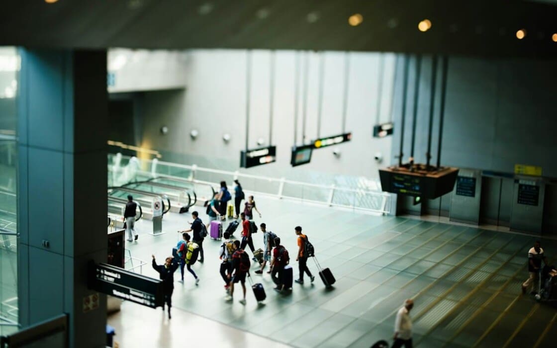 Group travelers inside an airport terminal before a group transfer
